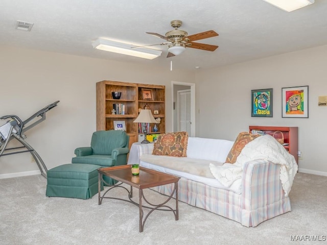 living room with ceiling fan and carpet