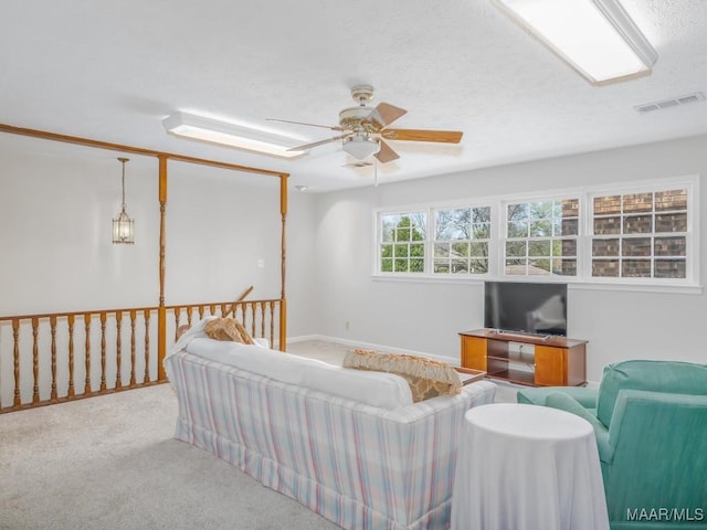 carpeted living room featuring ceiling fan