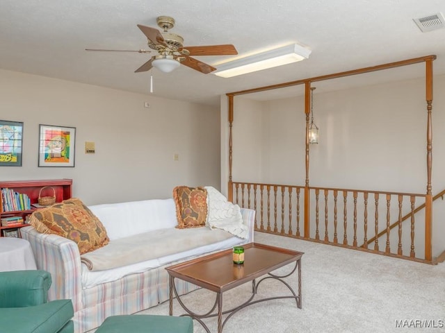 carpeted living room with ceiling fan