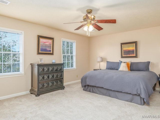 bedroom with light carpet and ceiling fan