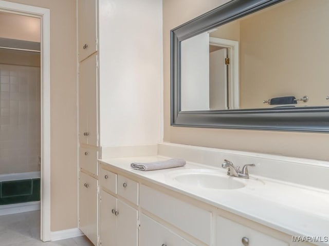 bathroom with tile patterned floors, vanity, and tiled shower / bath combo