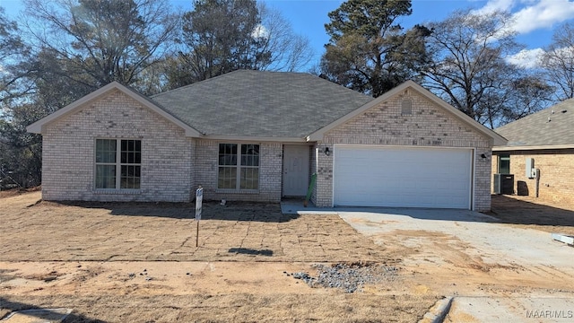 view of front of home featuring a garage and central air condition unit