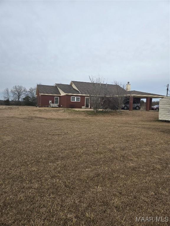 3601 Richardson Rd S, Hope Hull, AL 36043 - view of front of home with a carport, a front yard, and a chimney