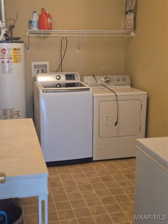 clothes washing area with washer and dryer and gas water heater