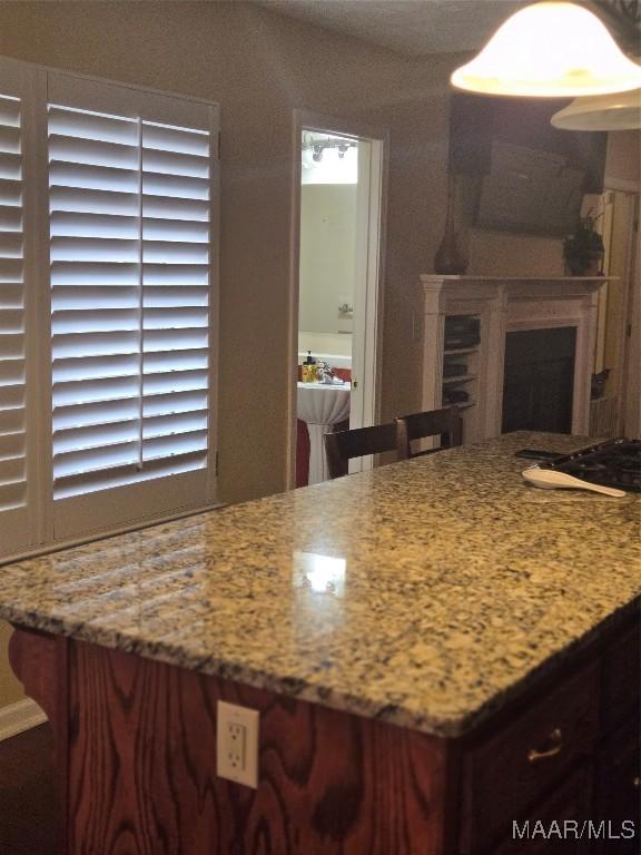 3601 Richardson Rd S, Hope Hull, AL 36043 - kitchen with light stone countertops and a fireplace