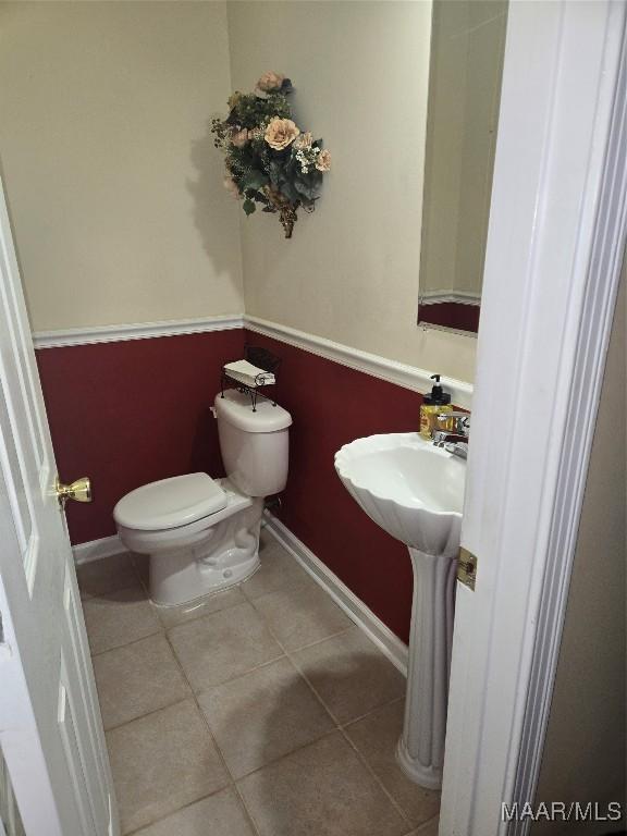 bathroom featuring toilet and tile patterned flooring