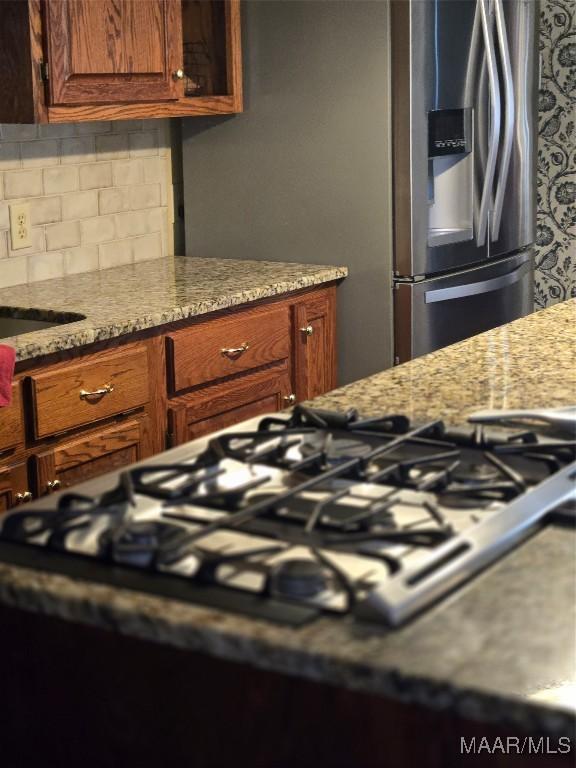 3601 Richardson Rd S, Hope Hull, AL 36043 - kitchen featuring gas stovetop, tasteful backsplash, stainless steel fridge with ice dispenser, and light stone countertops