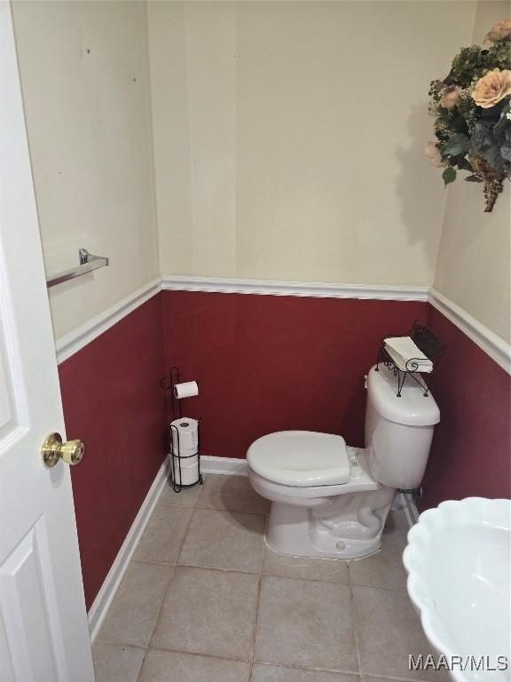 bathroom with toilet and tile patterned floors