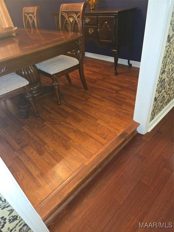 dining area featuring dark wood-type flooring