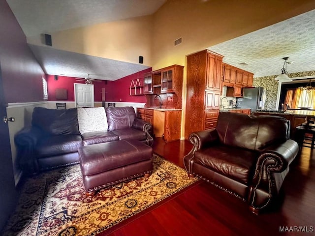 3601 Richardson Rd S, Hope Hull, AL 36043 - living area featuring wood finished floors, a ceiling fan, high vaulted ceiling, wallpapered walls, and a textured ceiling