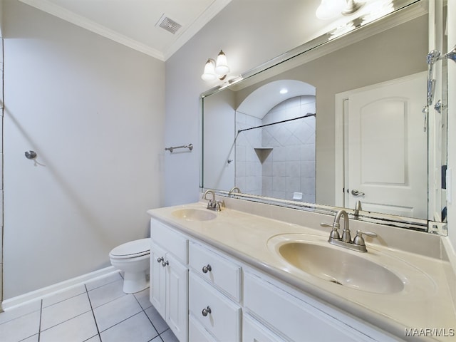 bathroom featuring a shower, vanity, toilet, crown molding, and tile patterned floors