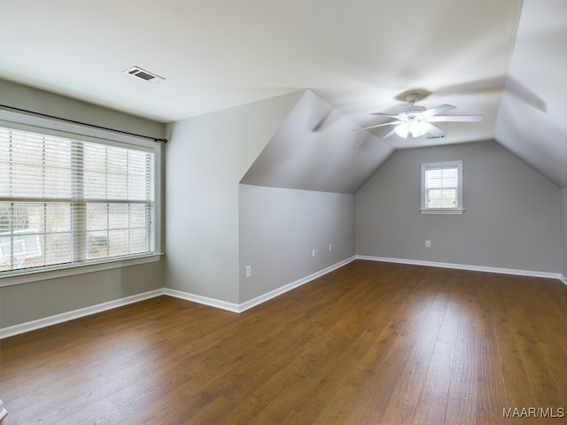 additional living space with vaulted ceiling, dark hardwood / wood-style floors, and ceiling fan