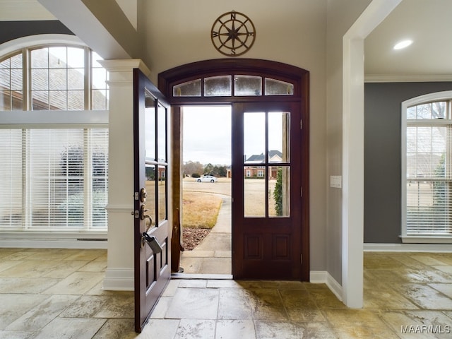 entryway featuring crown molding