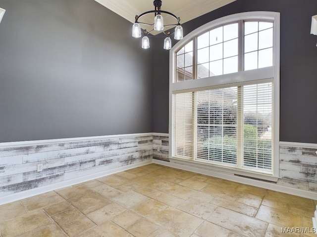 unfurnished room with a notable chandelier