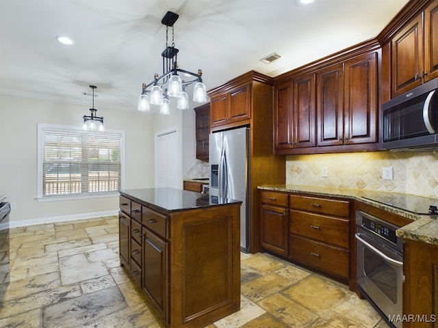 kitchen with appliances with stainless steel finishes, pendant lighting, tasteful backsplash, ornamental molding, and a center island