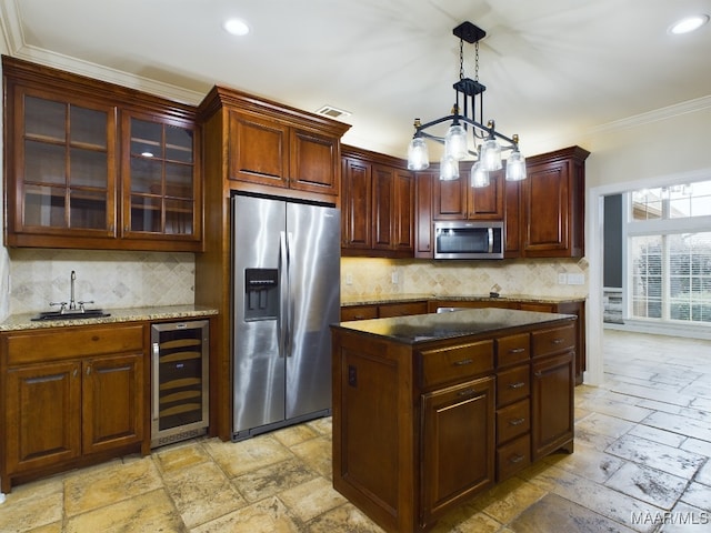 kitchen with wine cooler, sink, crown molding, hanging light fixtures, and stainless steel appliances