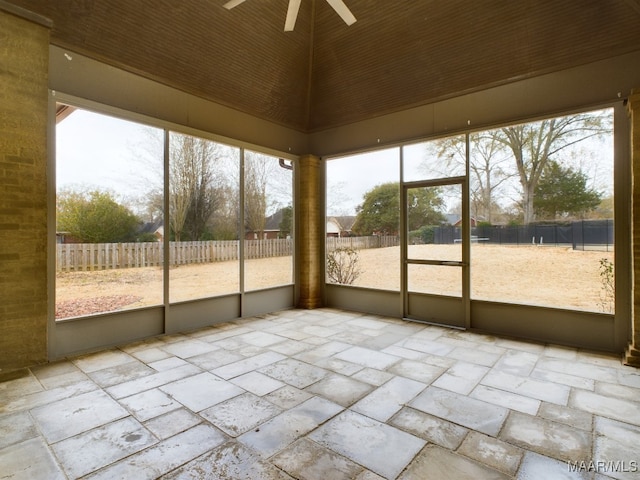 unfurnished sunroom with ceiling fan