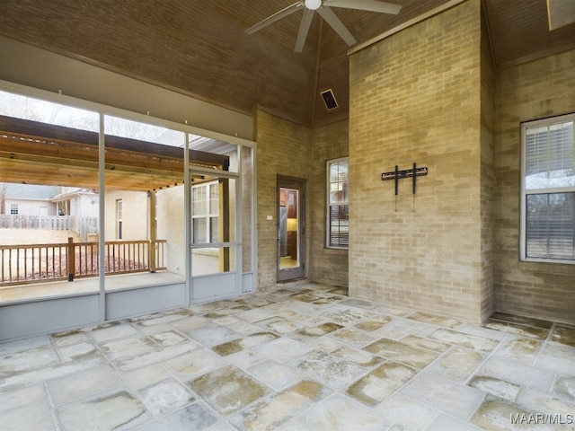 doorway to property with ceiling fan and a patio