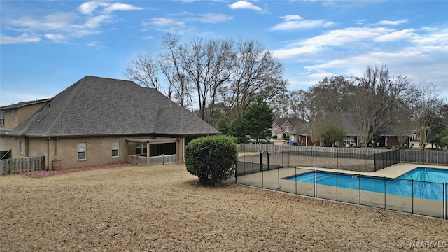 view of pool featuring a yard