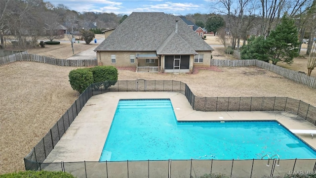 view of swimming pool with a patio area and a diving board