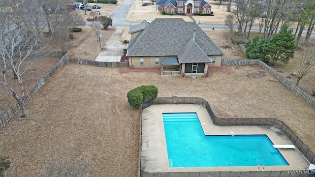 view of swimming pool with a patio area and a diving board