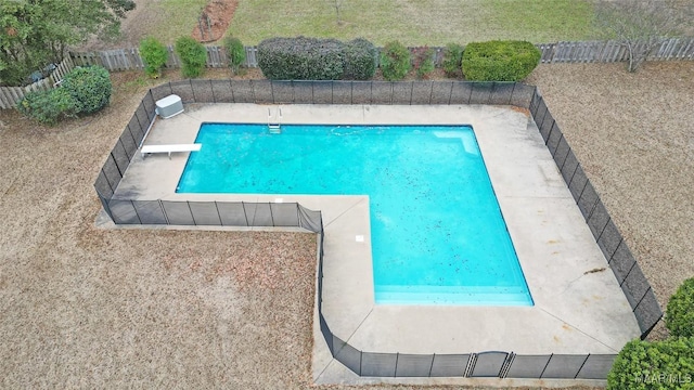 view of swimming pool featuring a diving board