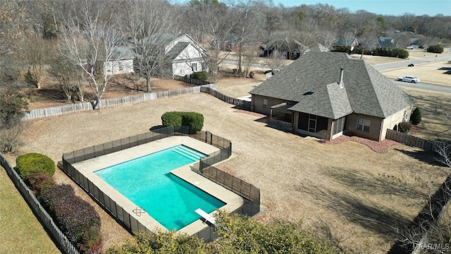 view of pool with a patio and a diving board