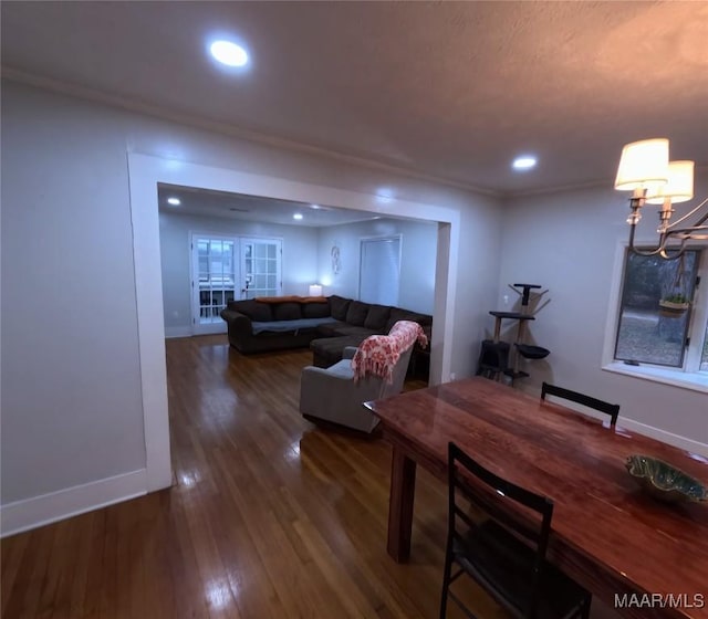 dining area featuring crown molding and dark hardwood / wood-style flooring