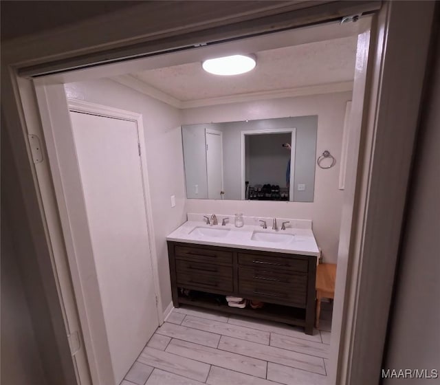 bathroom featuring crown molding, vanity, and hardwood / wood-style flooring