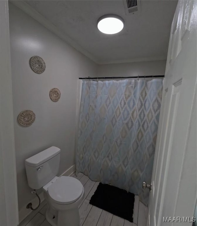 bathroom with walk in shower and toilet