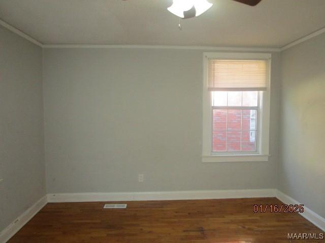 unfurnished room featuring crown molding, dark hardwood / wood-style floors, and ceiling fan