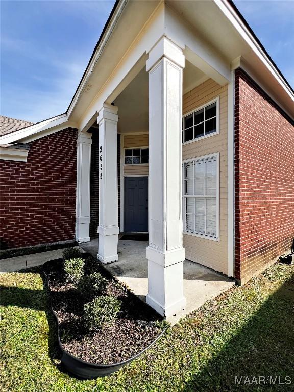 view of exterior entry featuring covered porch