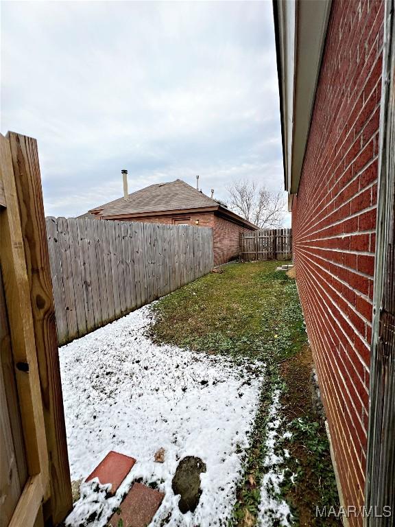 view of yard layered in snow