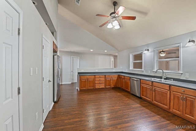 kitchen featuring stainless steel appliances, sink, dark hardwood / wood-style floors, vaulted ceiling, and ceiling fan