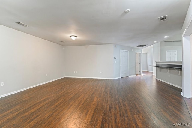 unfurnished living room with dark hardwood / wood-style flooring