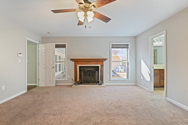 unfurnished living room featuring ceiling fan and light colored carpet