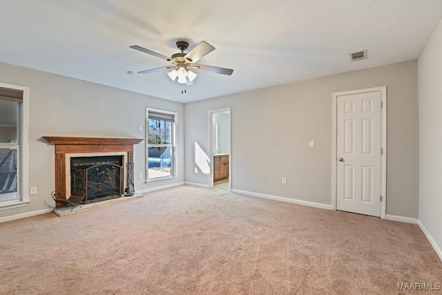 unfurnished living room featuring light colored carpet and ceiling fan