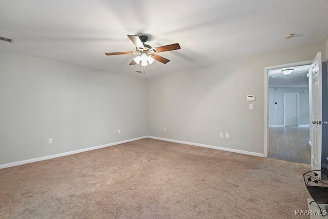 carpeted spare room with ceiling fan