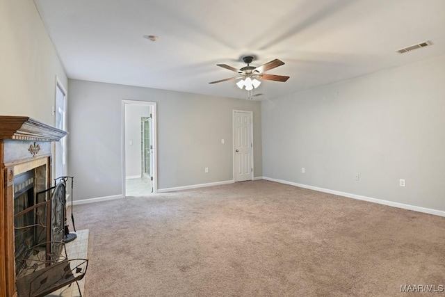 unfurnished living room with ceiling fan and carpet flooring