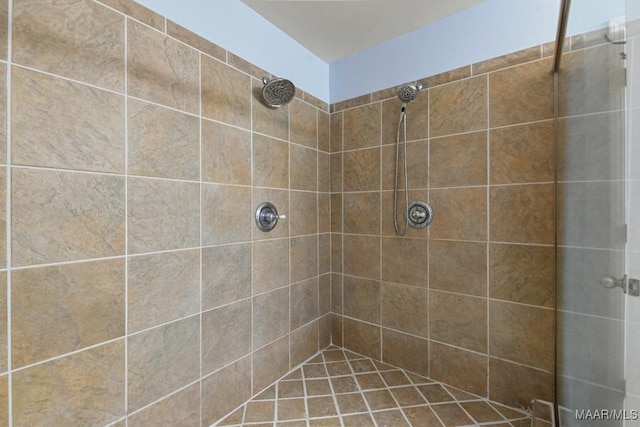 bathroom with a tile shower