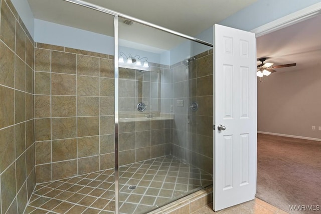 bathroom with ceiling fan, tile patterned floors, and a tile shower