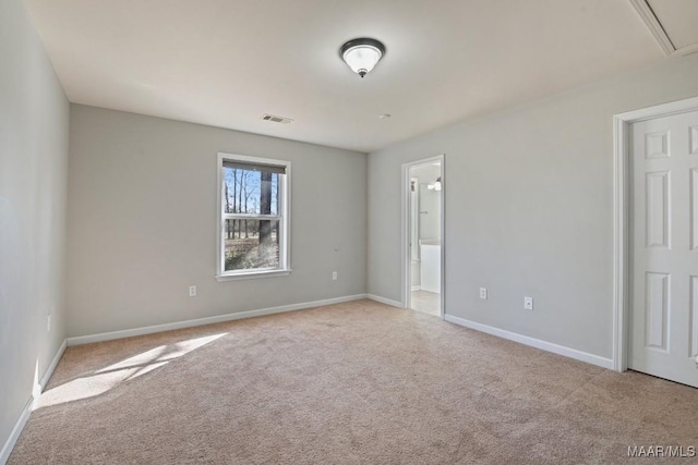 empty room featuring light carpet