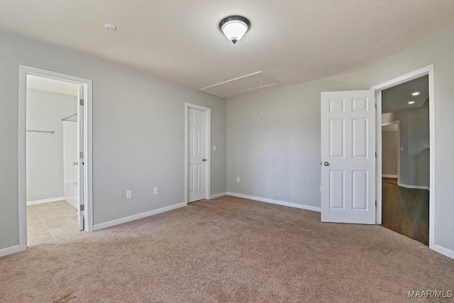 unfurnished bedroom with light colored carpet and ensuite bath