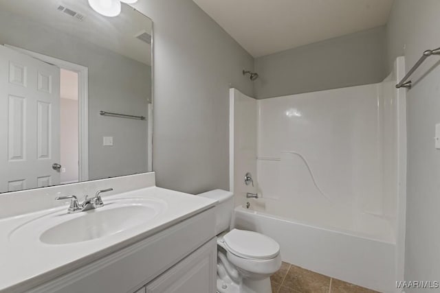 full bathroom featuring vanity, toilet,  shower combination, and tile patterned flooring