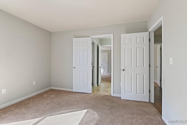 unfurnished bedroom with light colored carpet