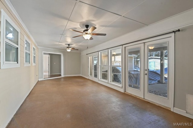 unfurnished room with ceiling fan, french doors, and concrete flooring