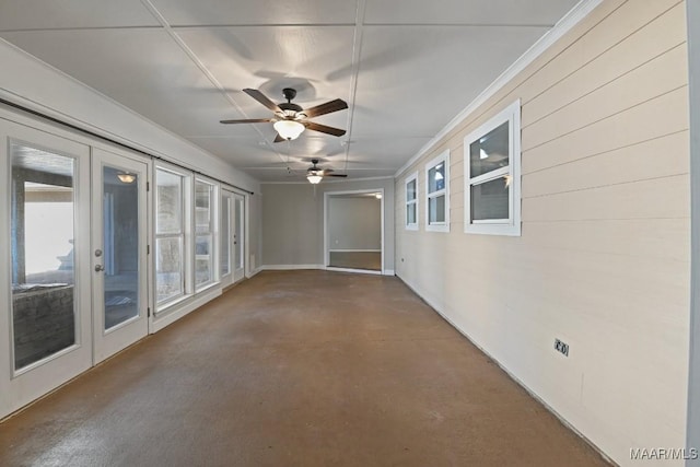 spare room featuring concrete flooring, ceiling fan, and french doors