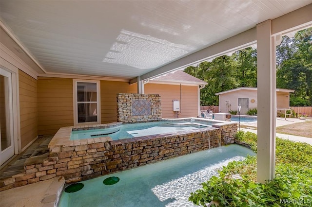 view of swimming pool with an in ground hot tub and pool water feature