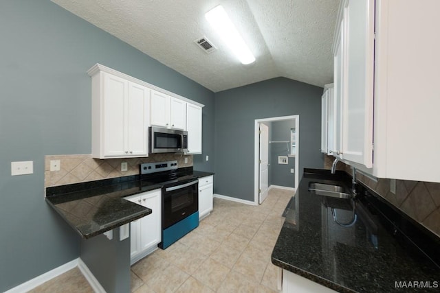 kitchen featuring lofted ceiling, white cabinetry, sink, backsplash, and electric range