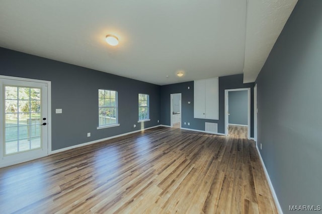 unfurnished living room with light hardwood / wood-style floors